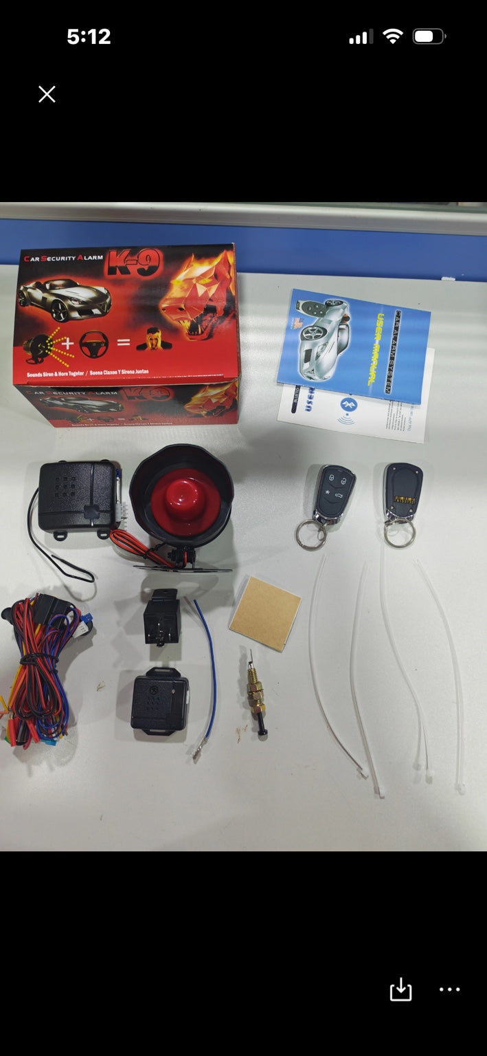 BT G01 vehicle alarm kit components including siren, wiring harnesses, remotes, control modules and manuals