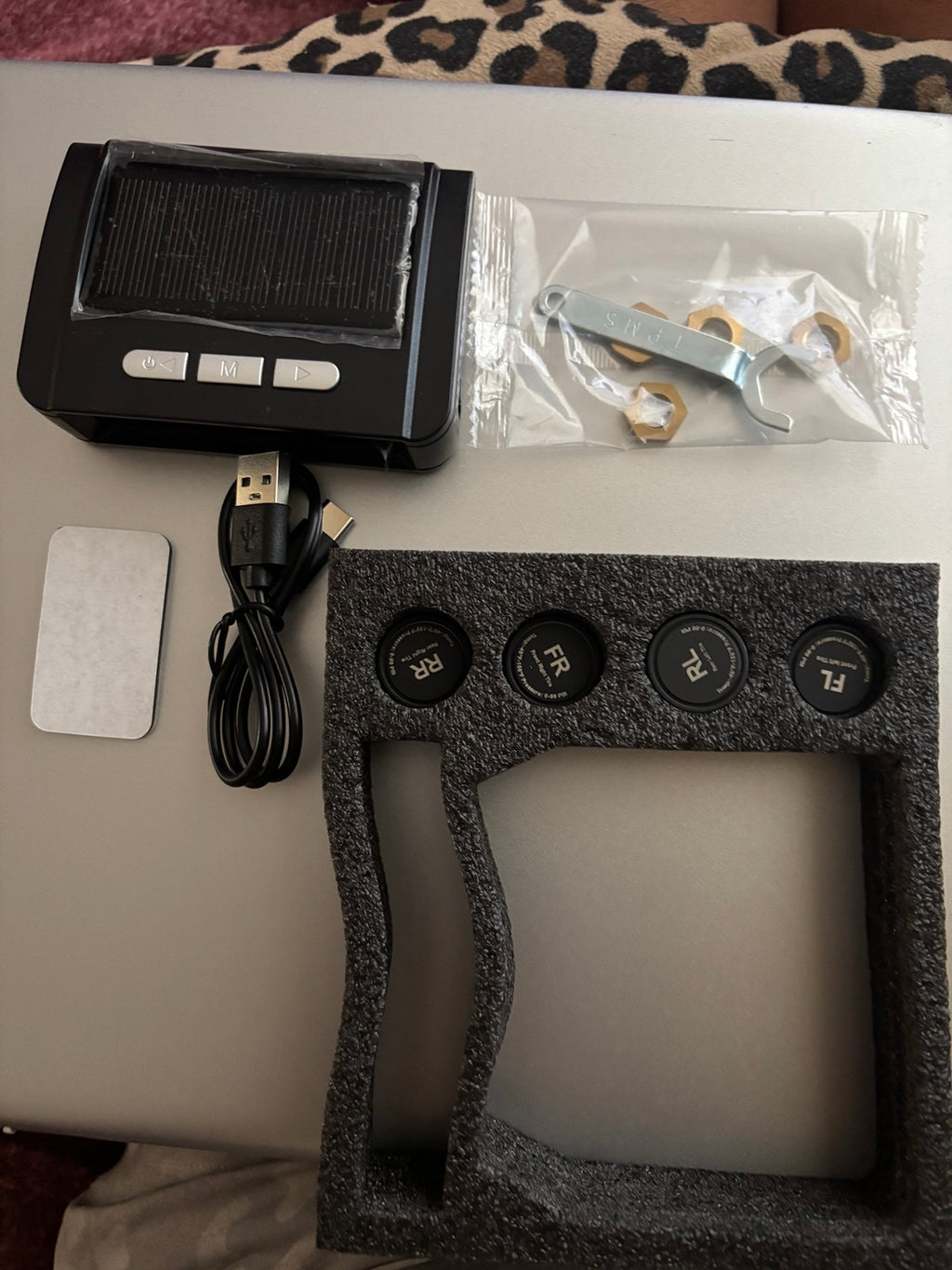 TPMS display, four external sensors, charging cable and installation hardware