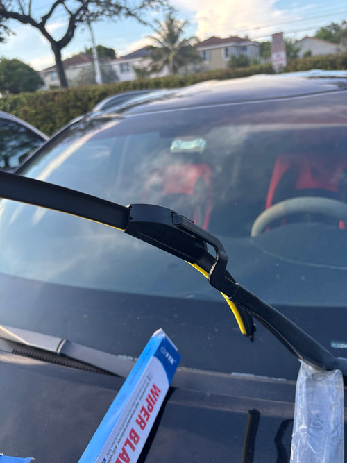 Universal flat windshield wiper blade installed on vehicle