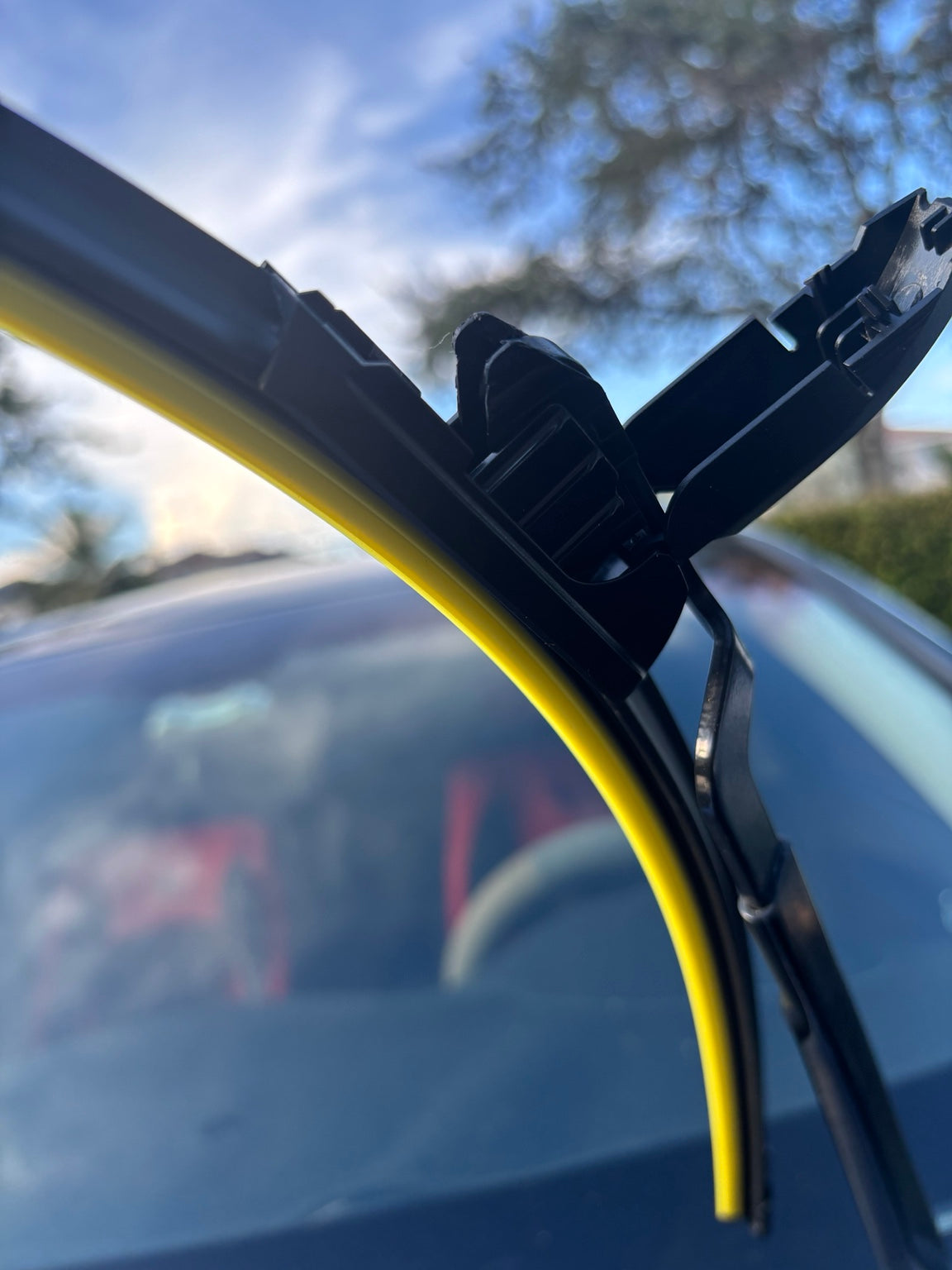 Close-up of U-hook windshield wiper blade installed on wiper arm